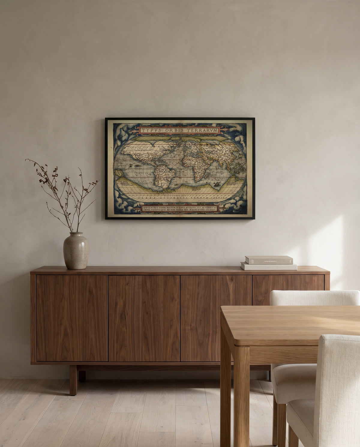 Typus Orbis Terrarum by Abraham Ortelius in a black frame above a walnut sideboard in a dining room