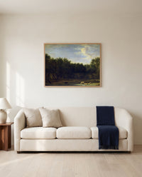 The Edge of a Wood by Adriaen van de Velde framed in natural oak above a cream sofa in a warm living room