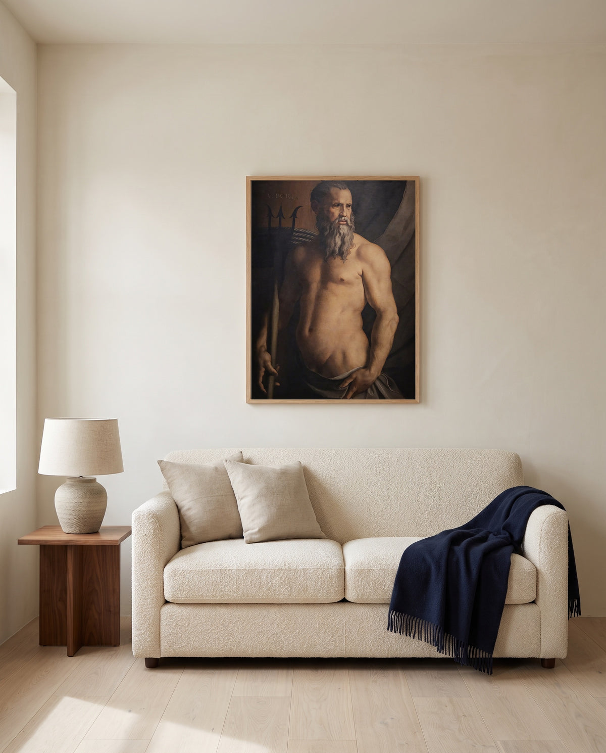Andrea Doria as Neptune by Agnolo Bronzino framed in natural oak above a cream sofa in a warm living room