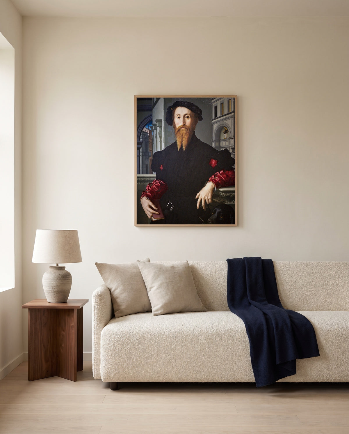 Bartolomeo Panciatichi by Agnolo Bronzino framed in natural oak above a cream sofa in a warm living room
