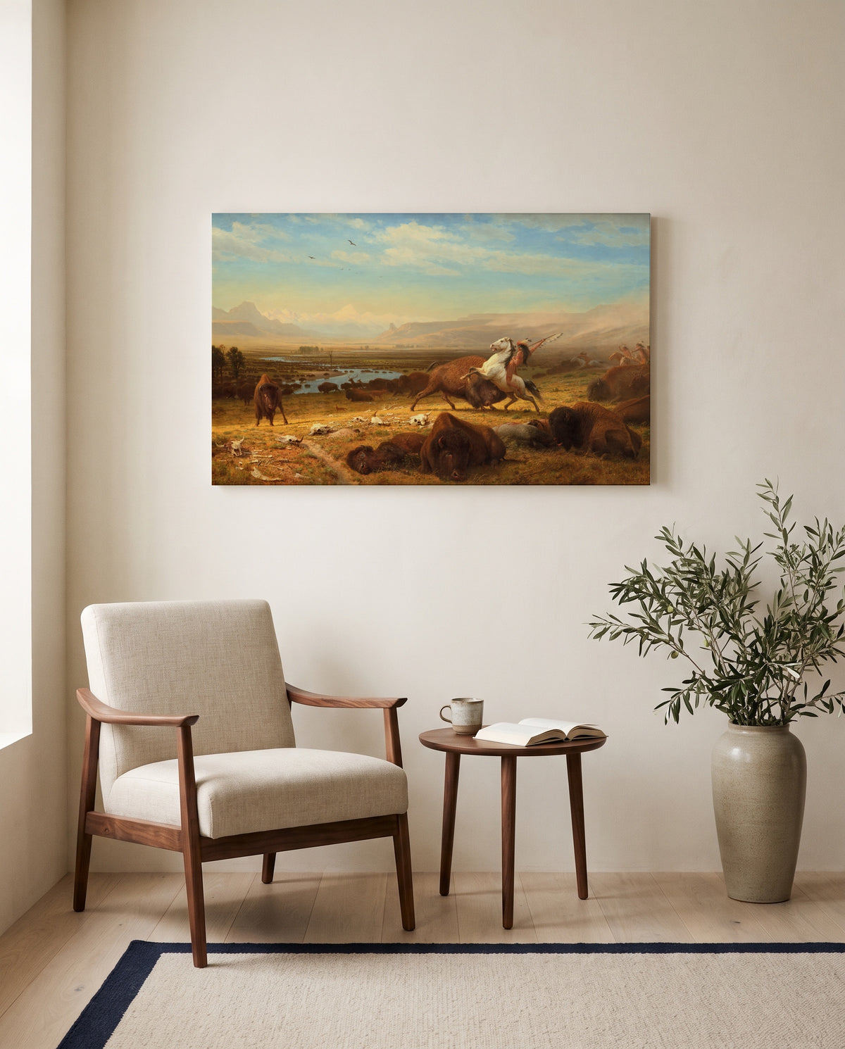 The Last of the Buffalo by Albert Bierstadt as a stretched canvas above a linen lounge chair in a reading corner