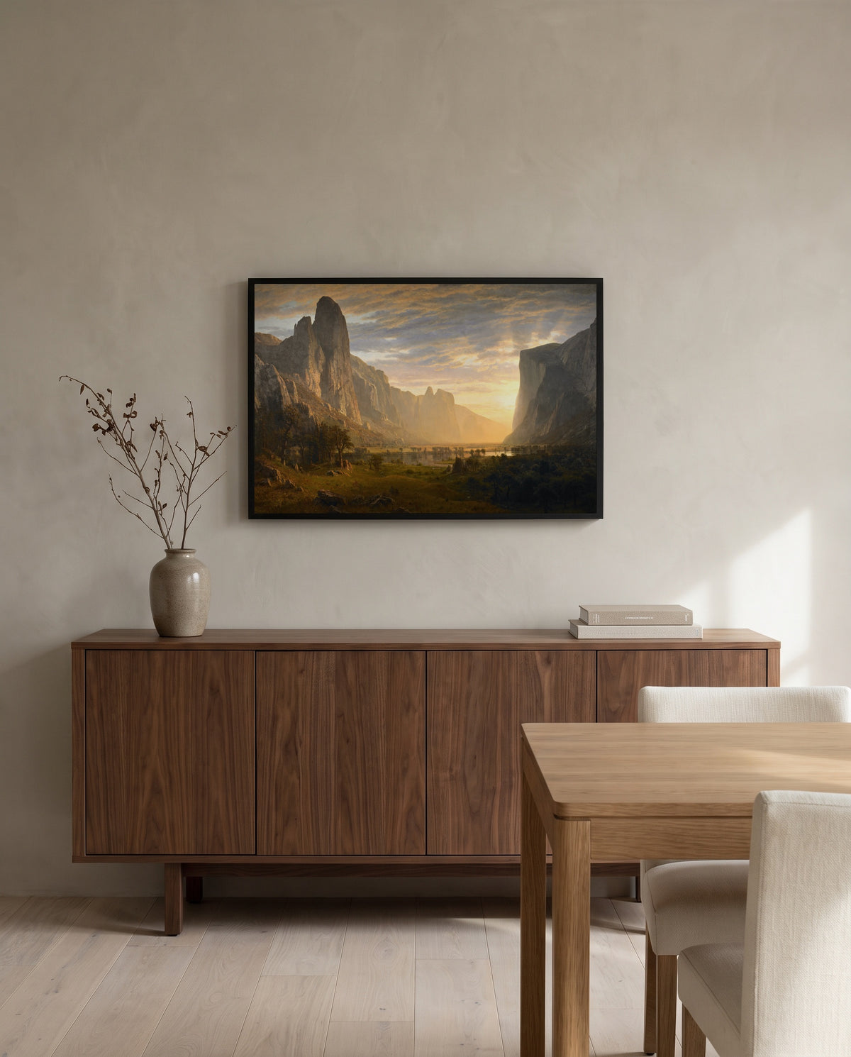 Looking Down Yosemite Valley by Albert Bierstadt in a black frame above a walnut sideboard in a dining room
