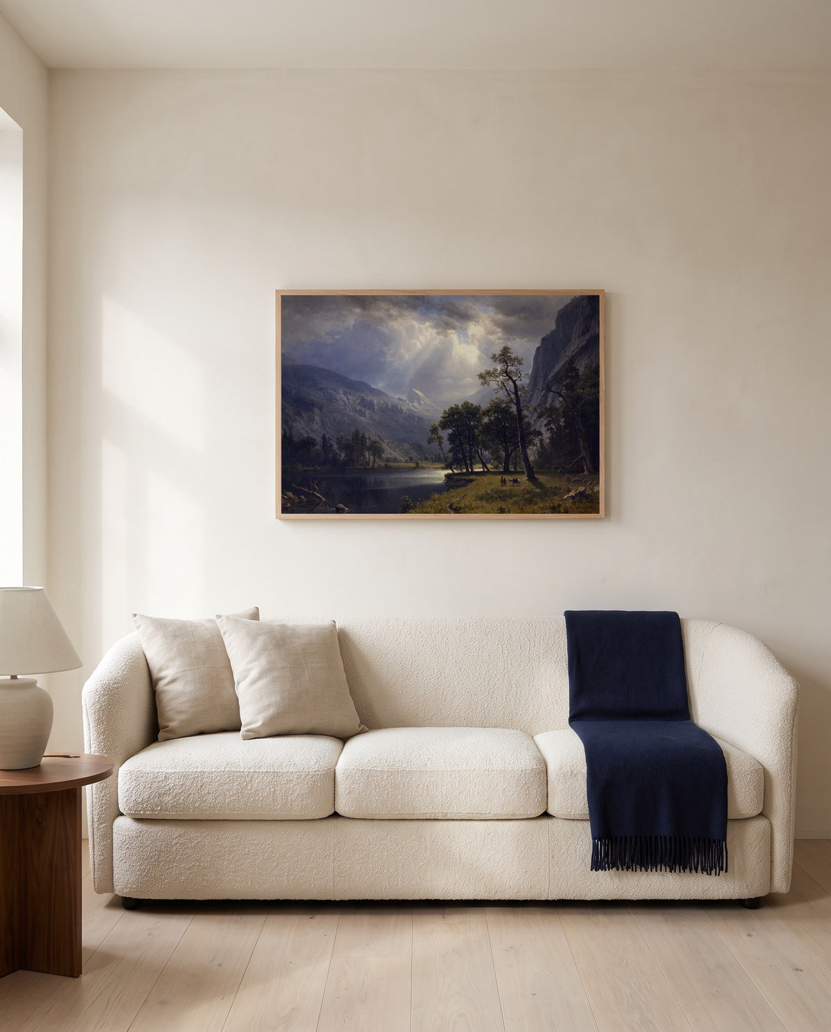 Mount Starr King, Yosemite by Albert Bierstadt framed in natural oak above a cream sofa in a warm living room