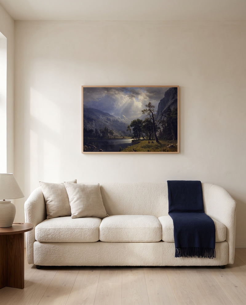 Mount Starr King, Yosemite by Albert Bierstadt framed in natural oak above a cream sofa in a warm living room