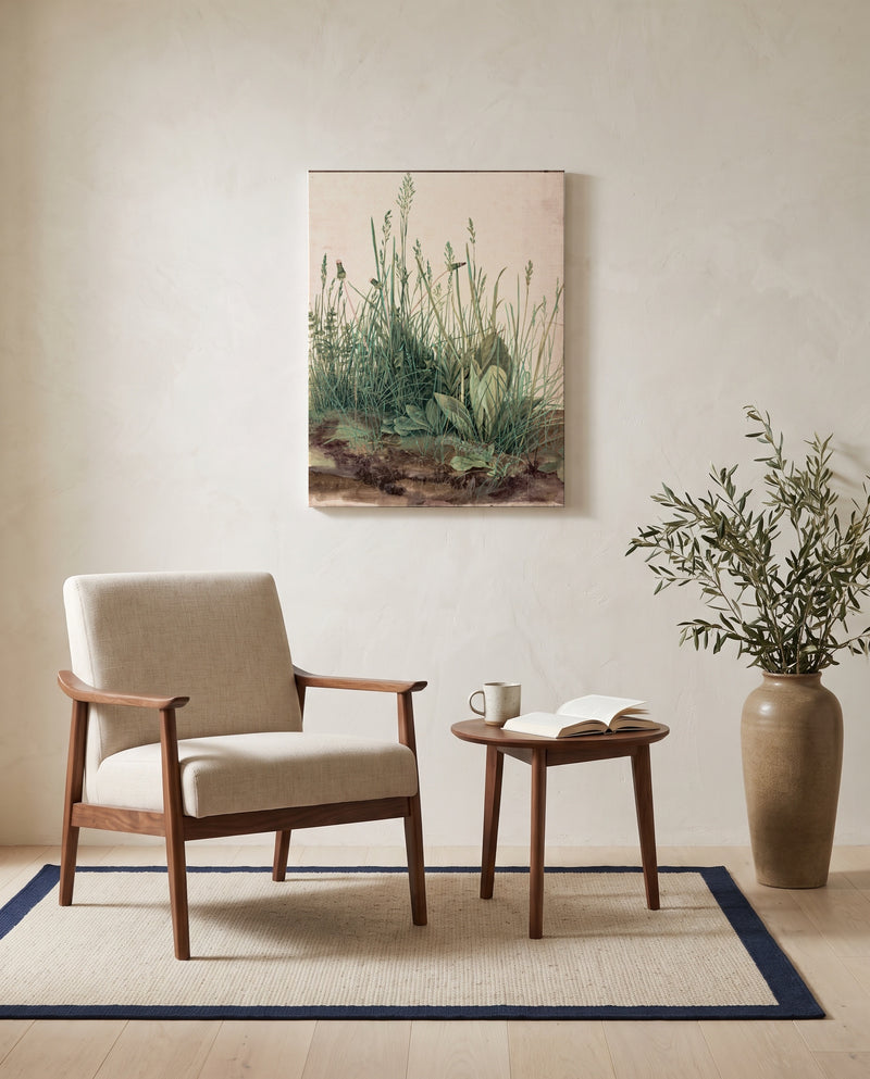 Great Piece of Turf by Albrecht Dürer as a stretched canvas above a linen lounge chair in a reading corner