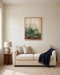 Great Piece of Turf by Albrecht Dürer framed in natural oak above a cream sofa in a warm living room