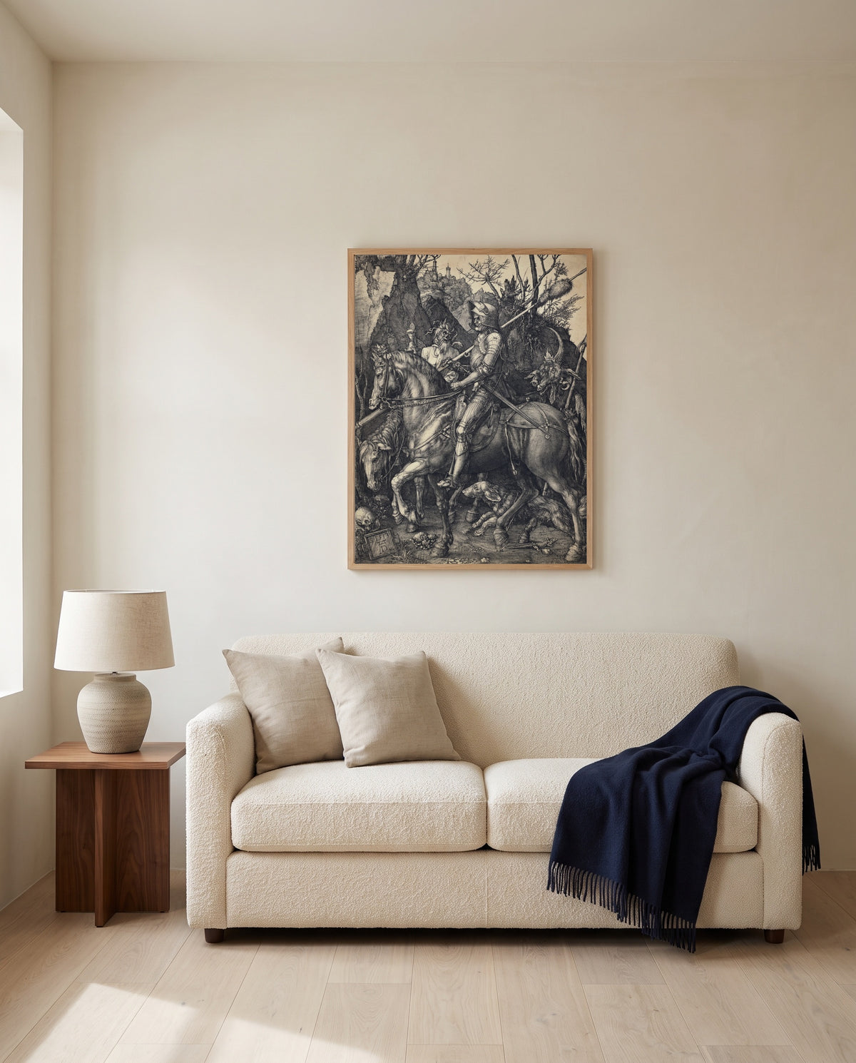 Knight, Death and the Devil by Albrecht Dürer framed in natural oak above a cream sofa in a warm living room