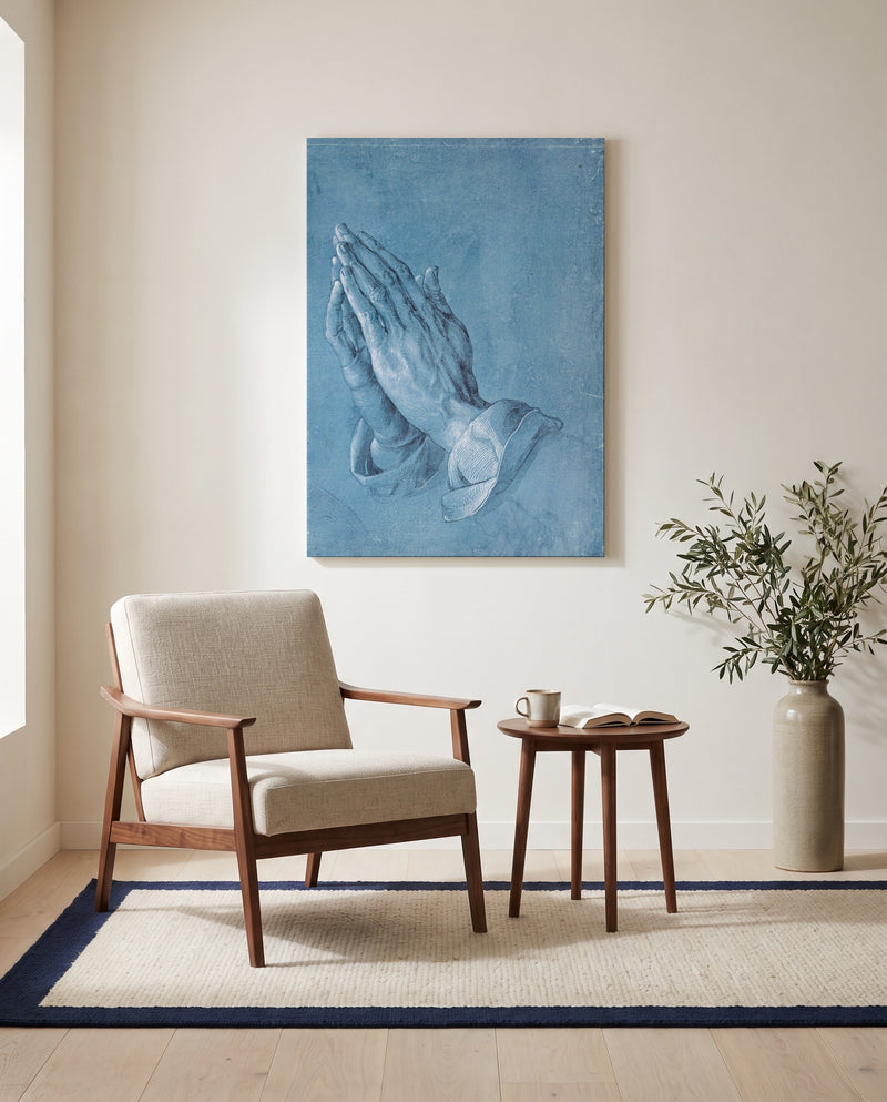 Praying Hands by Albrecht Dürer as a stretched canvas above a linen lounge chair in a reading corner