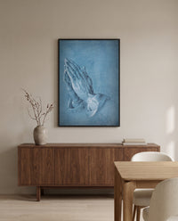 Praying Hands by Albrecht Dürer in a black frame above a walnut sideboard in a dining room