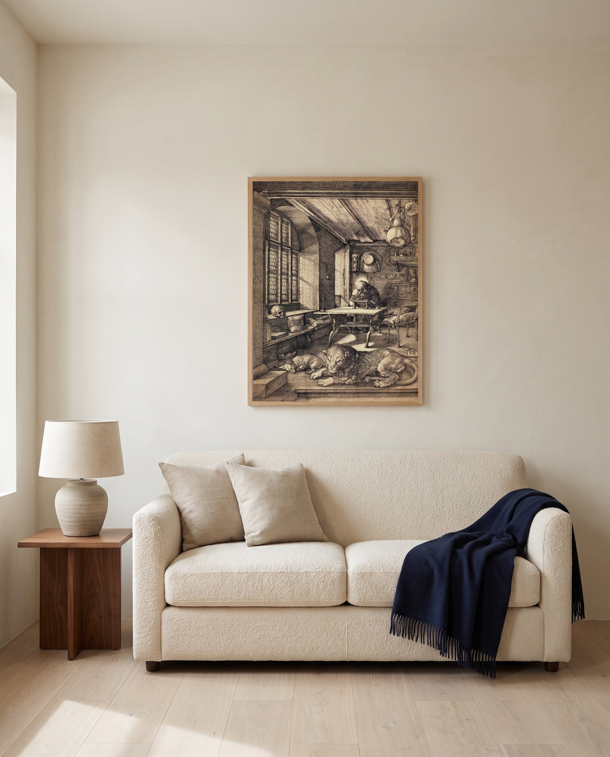 Saint Jerome in His Study by Albrecht Dürer framed in natural oak above a cream sofa in a warm living room