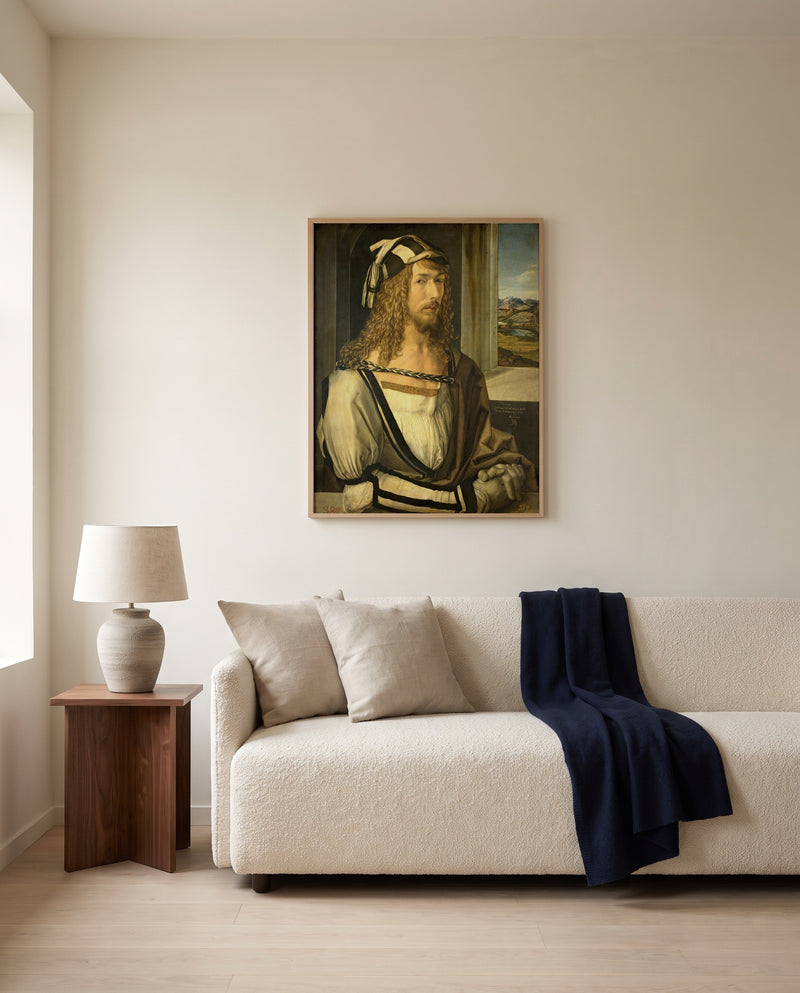 Self-Portrait (1498) by Albrecht Dürer framed in natural oak above a cream sofa in a warm living room