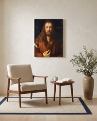 Self-Portrait (1500) by Albrecht Dürer as a stretched canvas above a linen lounge chair in a reading corner
