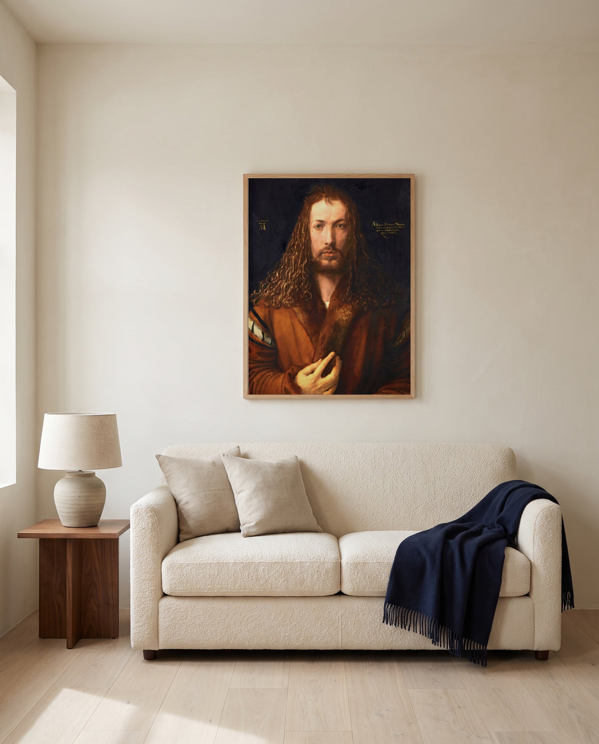 Self-Portrait (1500) by Albrecht Dürer framed in natural oak above a cream sofa in a warm living room