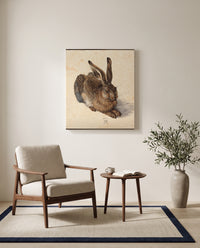 Young Hare by Albrecht Dürer as a stretched canvas above a linen lounge chair in a reading corner
