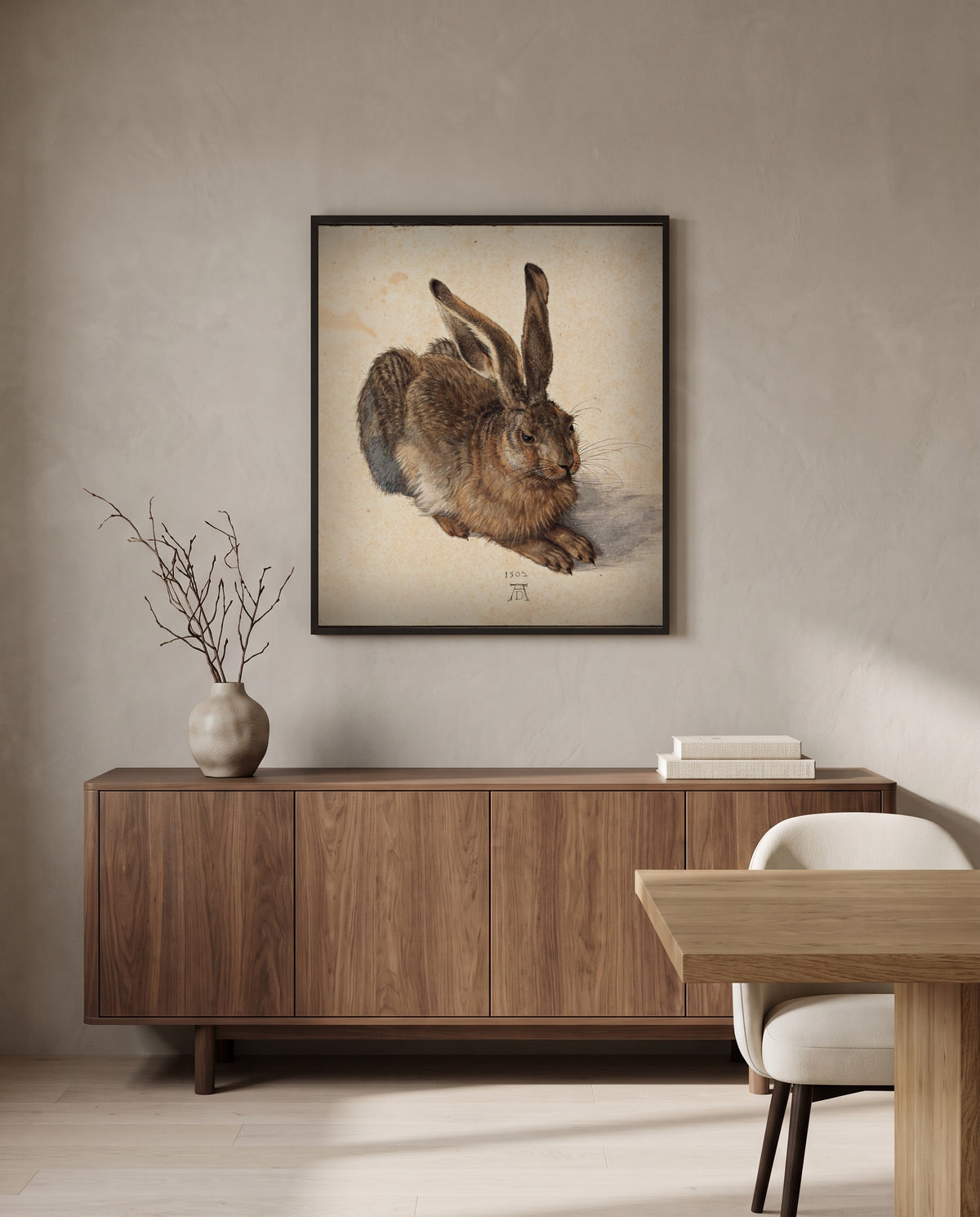 Young Hare by Albrecht Dürer in a black frame above a walnut sideboard in a dining room