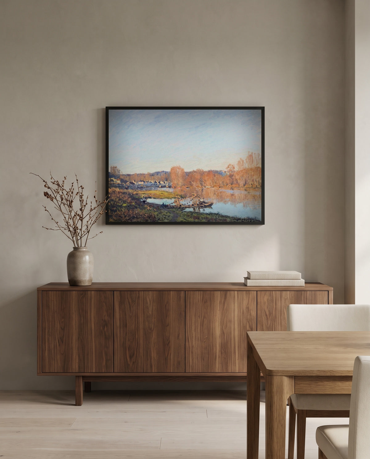 Autumn near Bougival by Alfred Sisley in a black frame above a walnut sideboard in a dining room