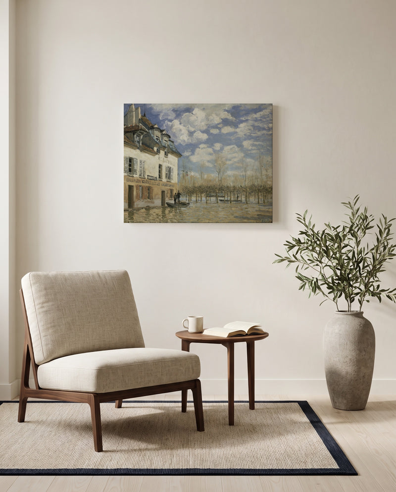 Boat in the Flood by Alfred Sisley as a stretched canvas above a linen lounge chair in a reading corner