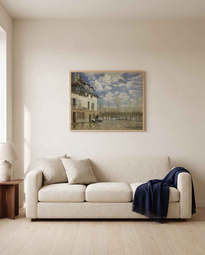 Boat in the Flood by Alfred Sisley framed in natural oak above a cream sofa in a warm living room
