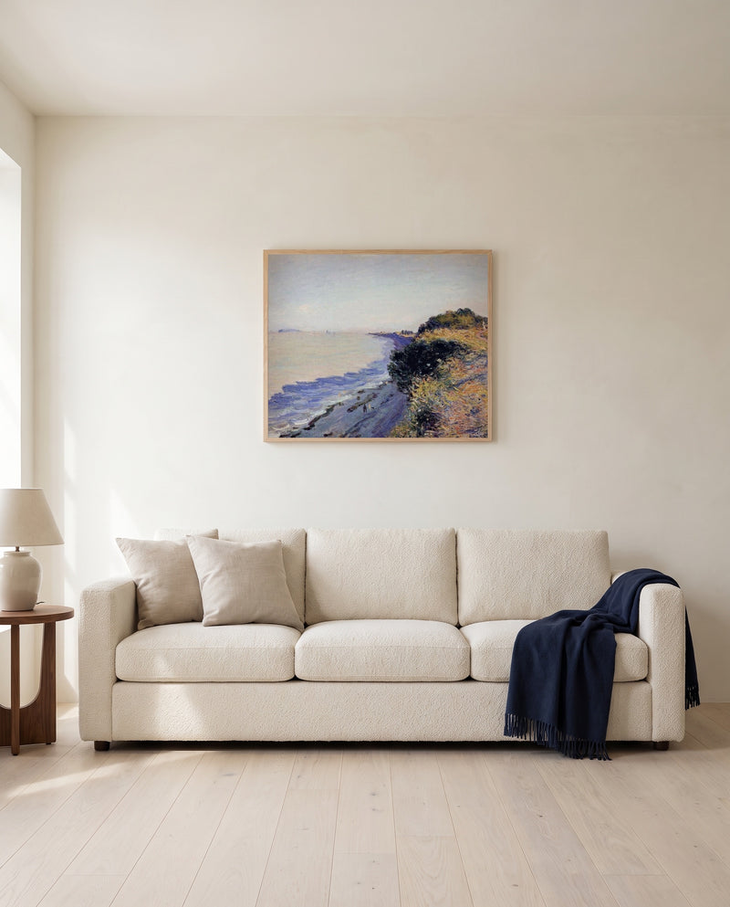 Bristol Channel, Evening by Alfred Sisley framed in natural oak above a cream sofa in a warm living room