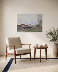 Evening in Moret by Alfred Sisley as a stretched canvas above a linen lounge chair in a reading corner