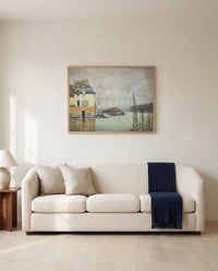 Flood at Port-Marly by Alfred Sisley framed in natural oak above a cream sofa in a warm living room