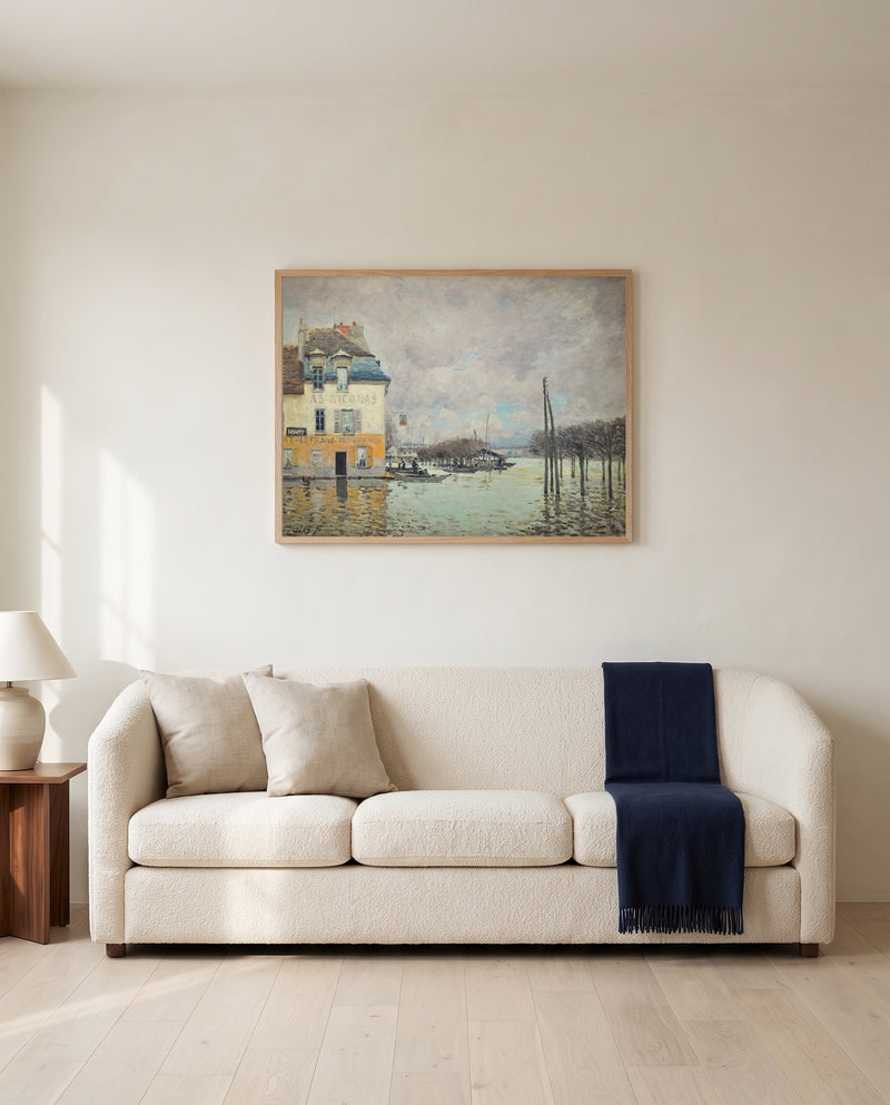 Flood at Port-Marly by Alfred Sisley framed in natural oak above a cream sofa in a warm living room