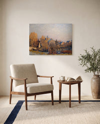Frost in Louveciennes by Alfred Sisley as a stretched canvas above a linen lounge chair in a reading corner