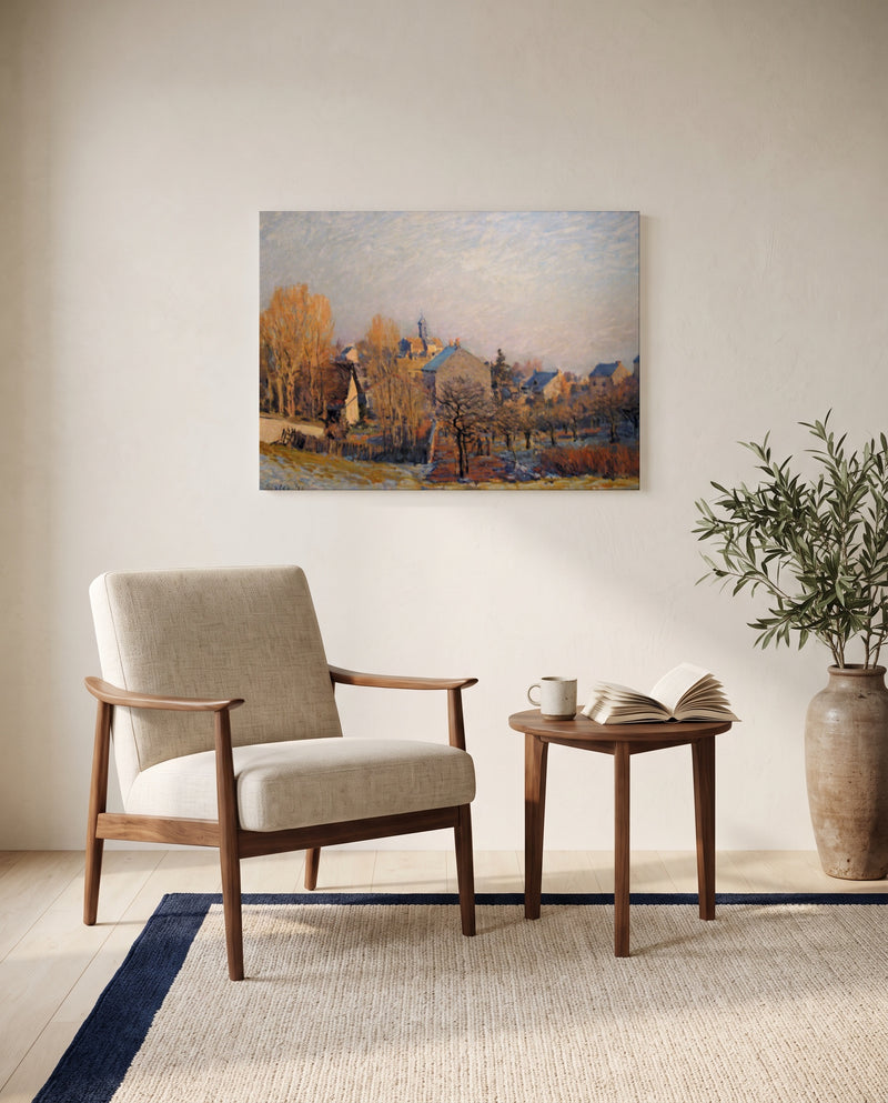 Frost in Louveciennes by Alfred Sisley as a stretched canvas above a linen lounge chair in a reading corner