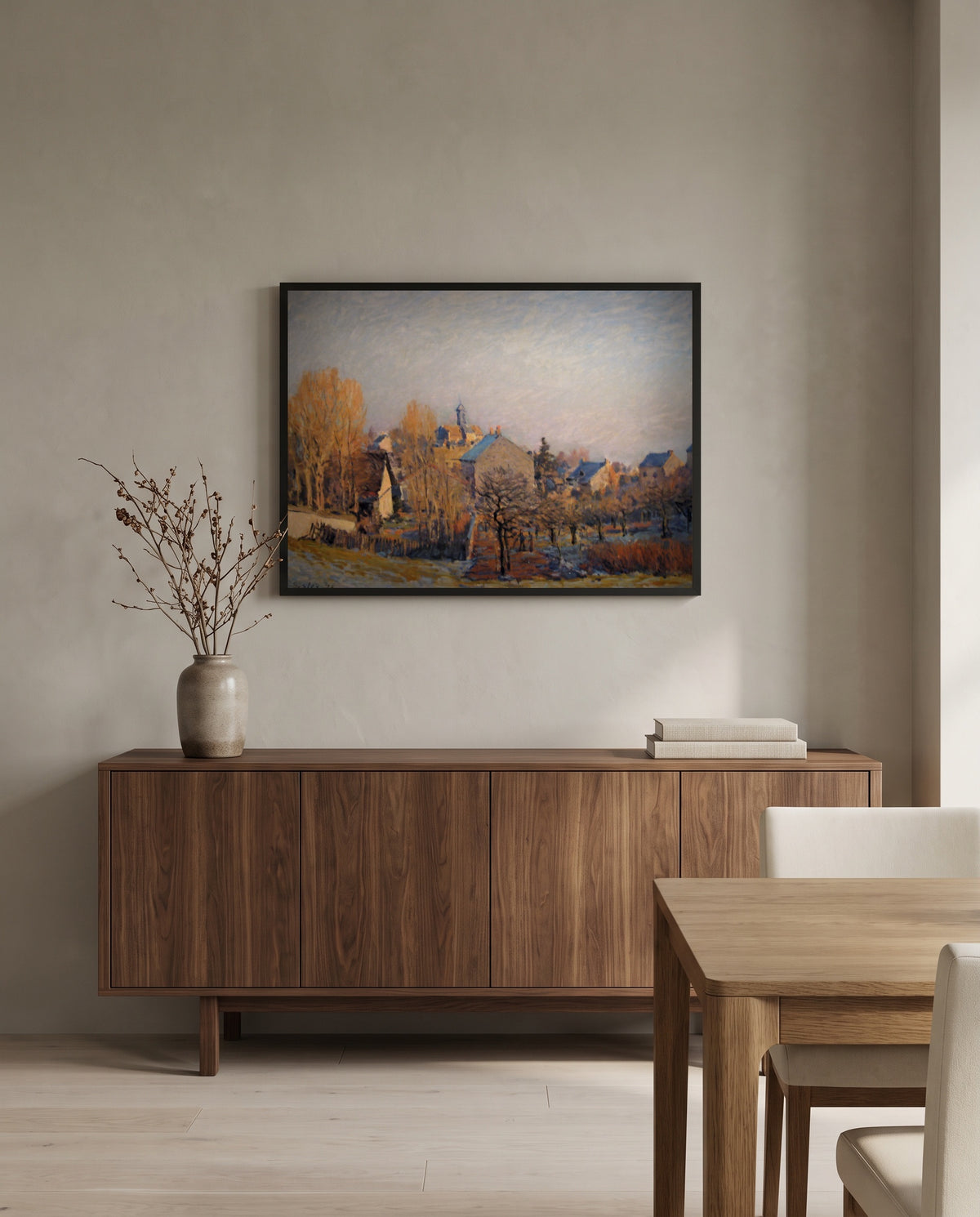 Frost in Louveciennes by Alfred Sisley in a black frame above a walnut sideboard in a dining room