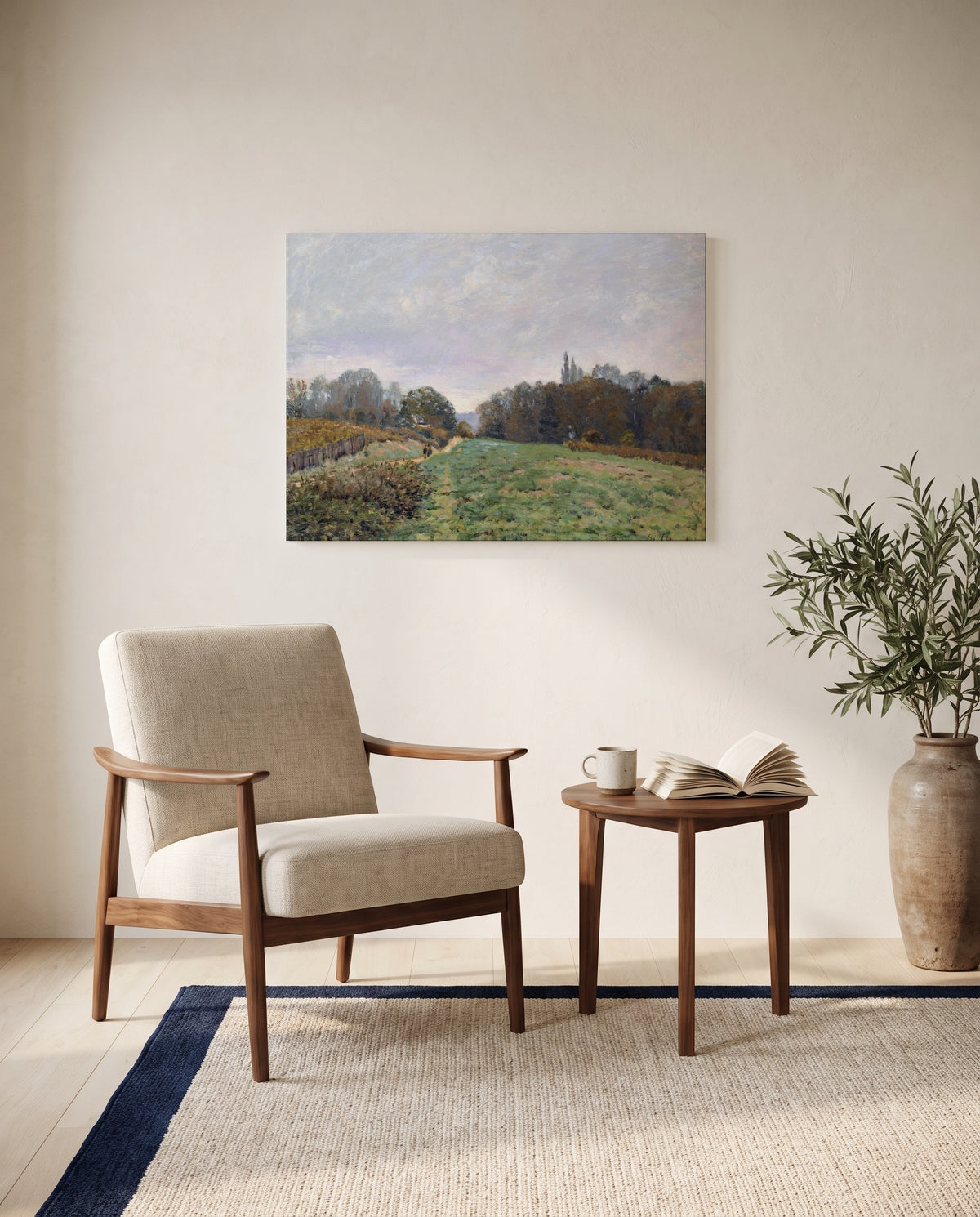 Landscape at Louveciennes by Alfred Sisley as a stretched canvas above a linen lounge chair in a reading corner