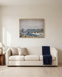 Molesey Weir by Alfred Sisley framed in natural oak above a cream sofa in a warm living room