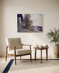 Near Moret-sur-Loing by Alfred Sisley as a stretched canvas above a linen lounge chair in a reading corner