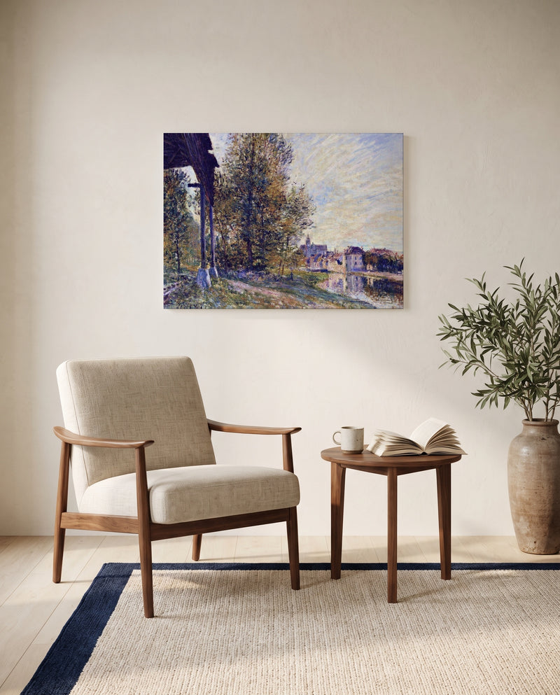 Near Moret-sur-Loing by Alfred Sisley as a stretched canvas above a linen lounge chair in a reading corner