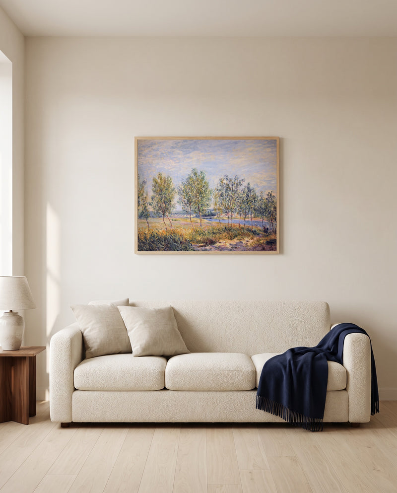 Poplars on a River Bank by Alfred Sisley framed in natural oak above a cream sofa in a warm living room
