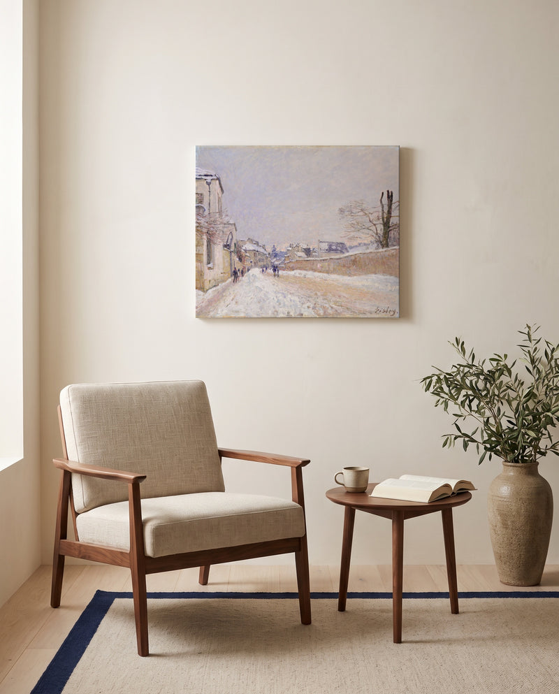 Moret in Winter by Alfred Sisley as a stretched canvas above a linen lounge chair in a reading corner