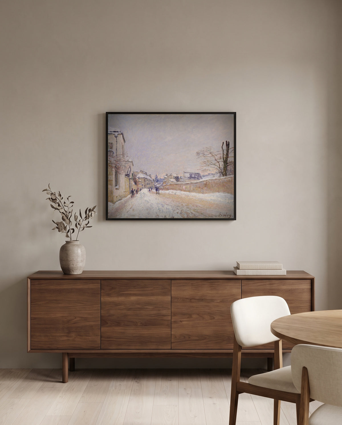 Moret in Winter by Alfred Sisley in a black frame above a walnut sideboard in a dining room