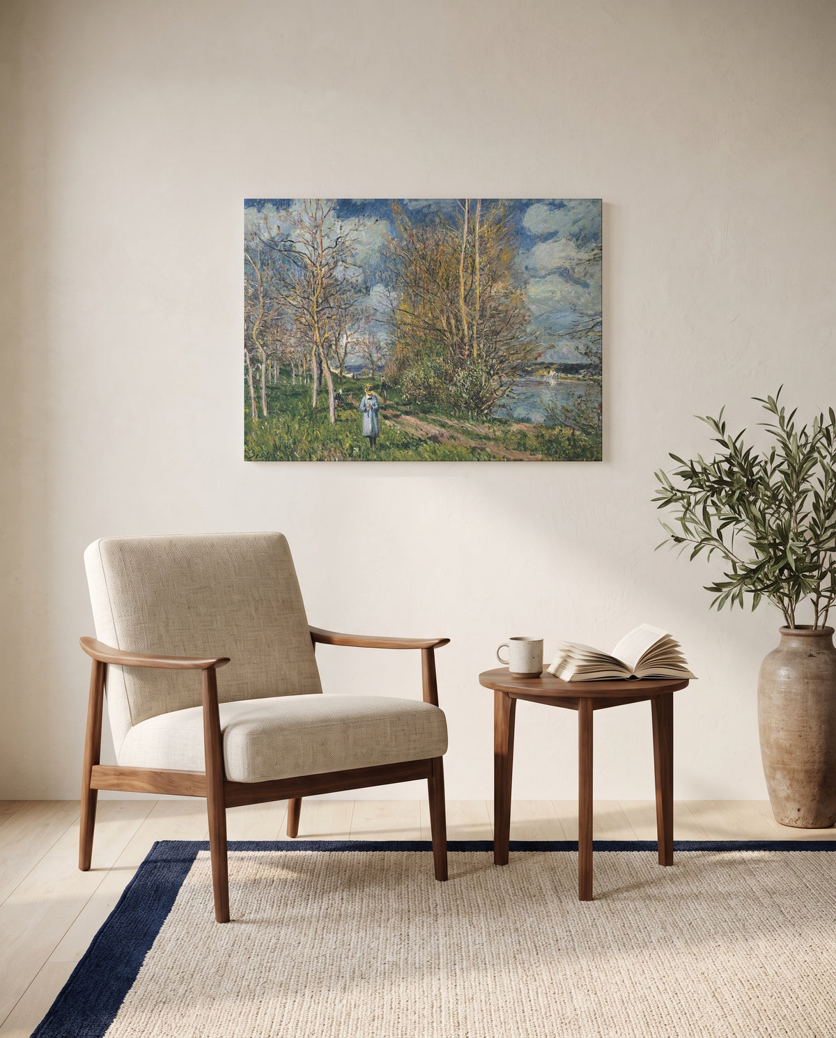 Small Meadows in Spring by Alfred Sisley as a stretched canvas above a linen lounge chair in a reading corner