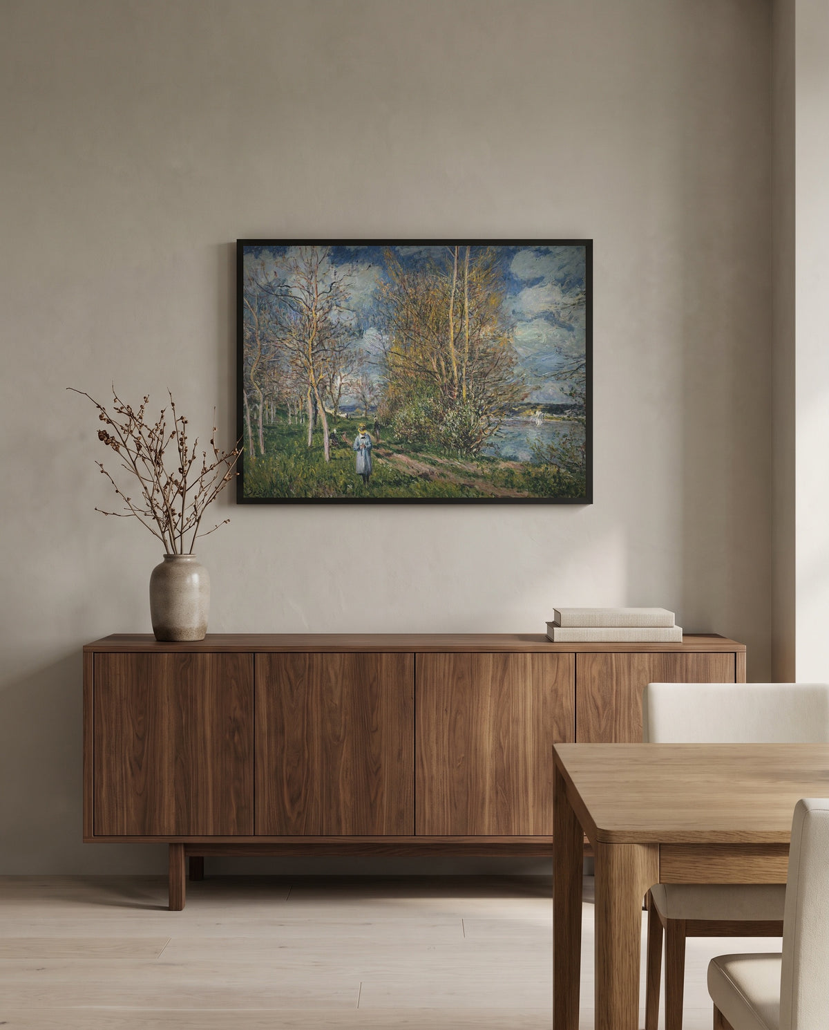 Small Meadows in Spring by Alfred Sisley in a black frame above a walnut sideboard in a dining room