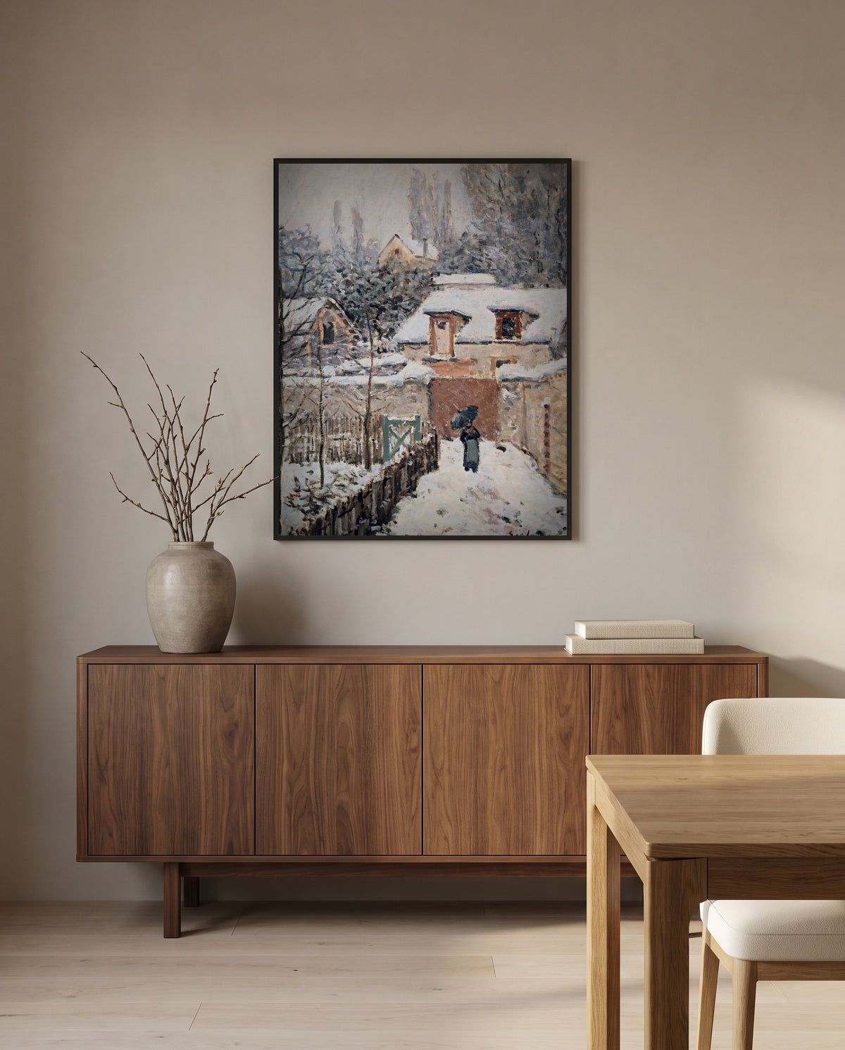 Snow at Louveciennes by Alfred Sisley in a black frame above a walnut sideboard in a dining room