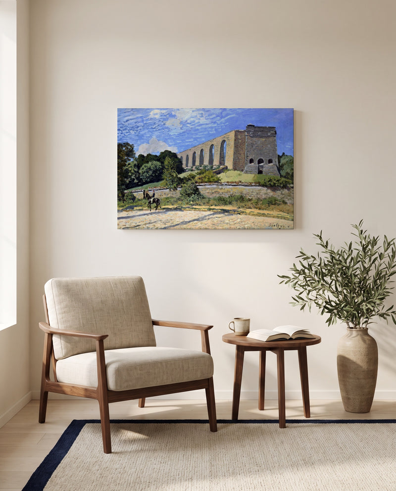 The Aqueduct at Marly by Alfred Sisley as a stretched canvas above a linen lounge chair in a reading corner