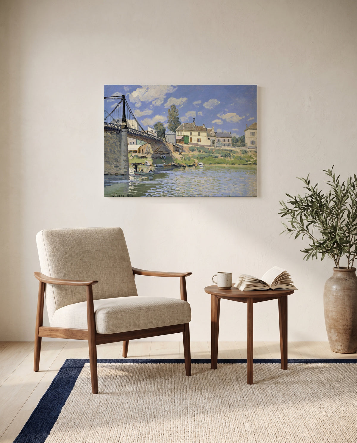Bridge at Villeneuve by Alfred Sisley as a stretched canvas above a linen lounge chair in a reading corner