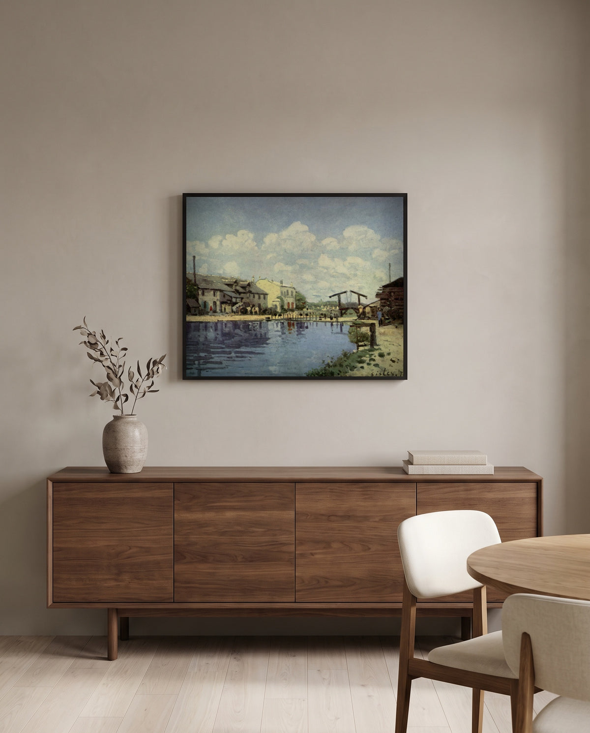 The Canal Saint-Martin by Alfred Sisley in a black frame above a walnut sideboard in a dining room