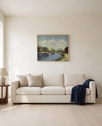 The Canal Saint-Martin by Alfred Sisley framed in natural oak above a cream sofa in a warm living room