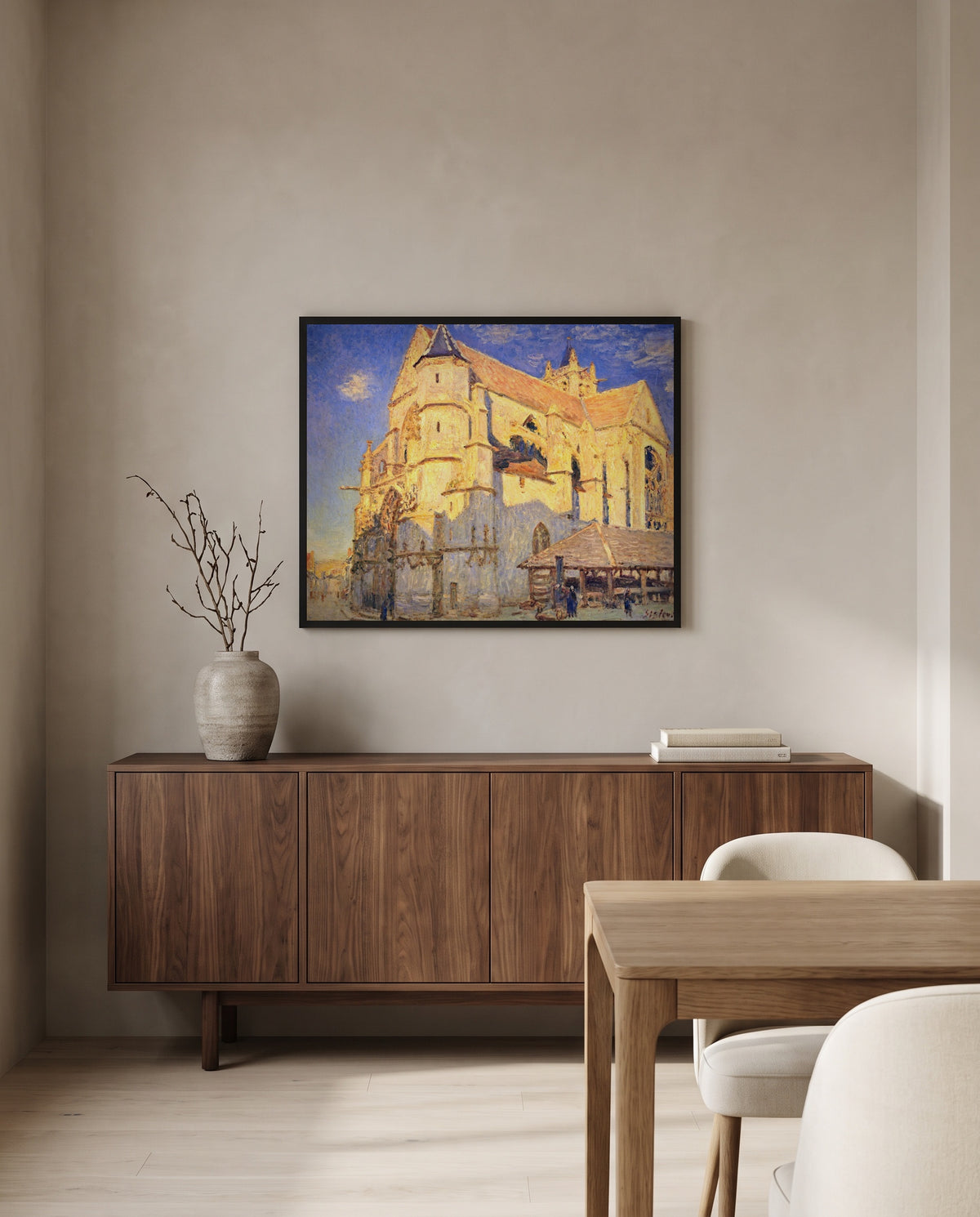 Church at Moret by Alfred Sisley in a black frame above a walnut sideboard in a dining room