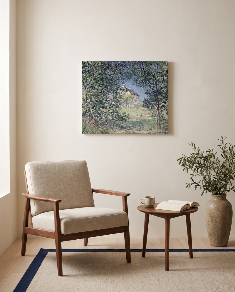 Forest Edge in Spring by Alfred Sisley as a stretched canvas above a linen lounge chair in a reading corner