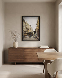 Grand-Rue in Argenteuil by Alfred Sisley in a black frame above a walnut sideboard in a dining room