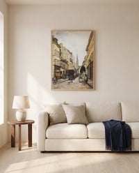 Grand-Rue in Argenteuil by Alfred Sisley framed in natural oak above a cream sofa in a warm living room