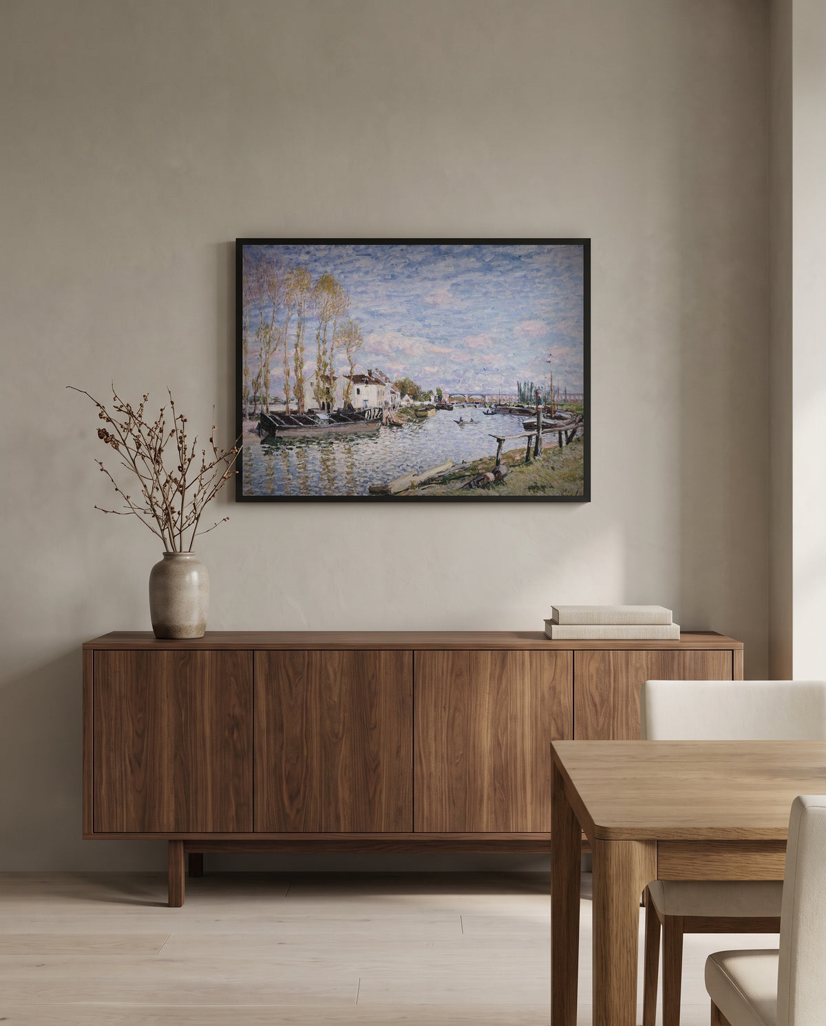 Loing at Saint-Mammès by Alfred Sisley in a black frame above a walnut sideboard in a dining room