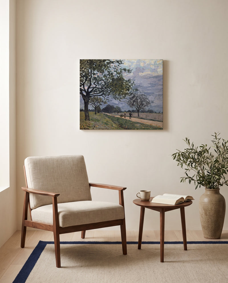 Road to Louveciennes by Alfred Sisley as a stretched canvas above a linen lounge chair in a reading corner