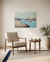 The Seine at Port-Marly by Alfred Sisley as a stretched canvas above a linen lounge chair in a reading corner